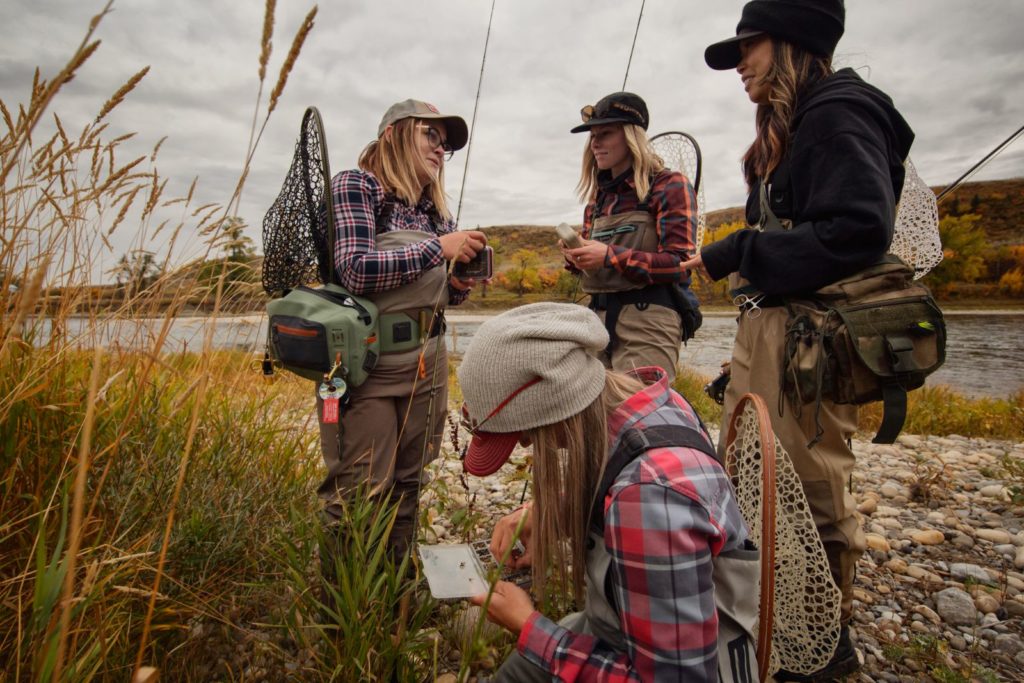 Four young women with fishing gear at Lesser Slave Lake, about to go fishing
